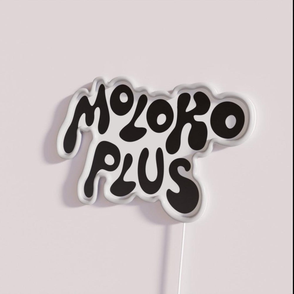 Moloko Plus Rgb Led Neon Sign - Neon sign mounted on wall in room