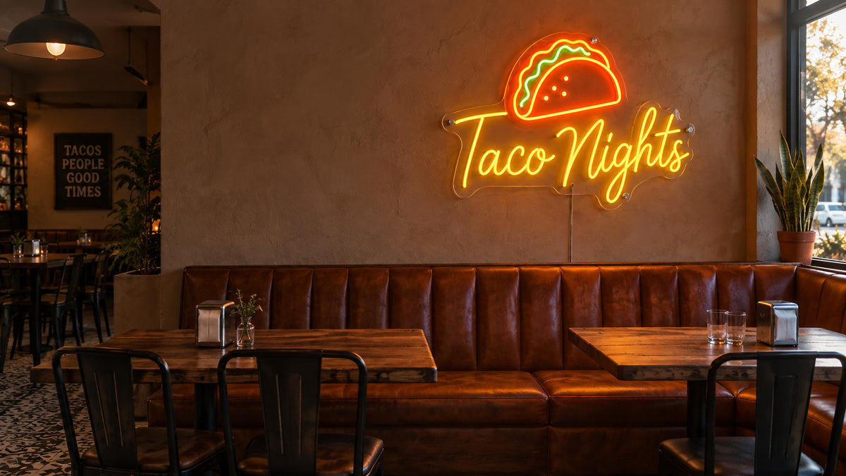Taco Nights LED neon wall decoration in a restaurant with leather booth seating and wooden tables.