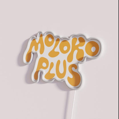 Moloko Plus Orange Rgb Led Neon Sign - Neon sign mounted on wall in room