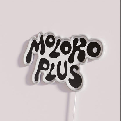 Moloko Plus Rgb Led Neon Sign - Neon sign mounted on wall in room