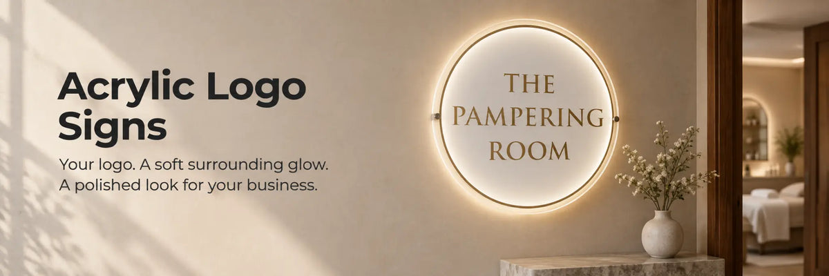 Round acrylic business logo sign with soft warm backlighting in a refined spa interior.