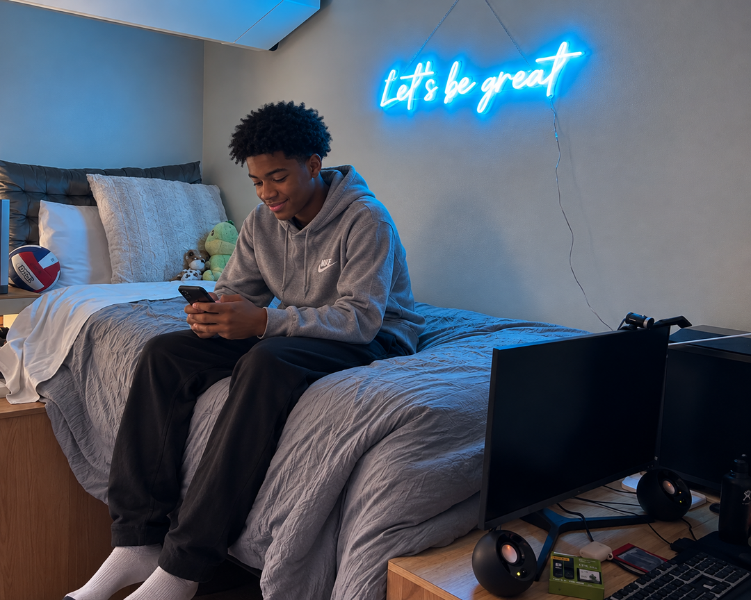 Blue Let's be great neon sign above a bed in a personal bedroom.