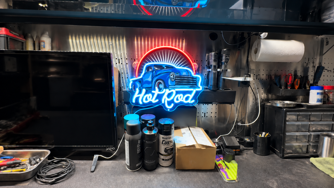Blue and red Hot Rod neon sign above a garage workbench.