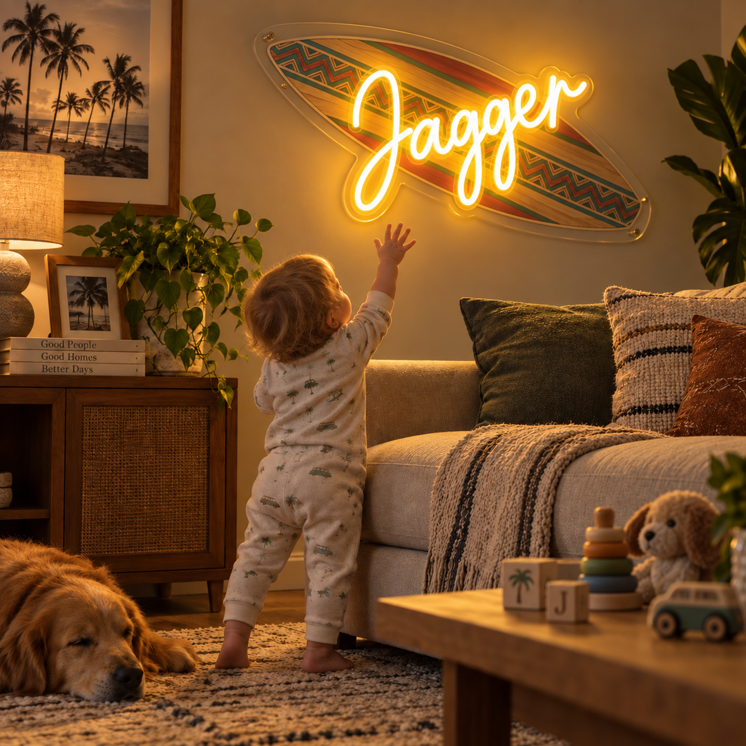 Warm yellow Jagger neon sign on a surfboard above a living room sofa.