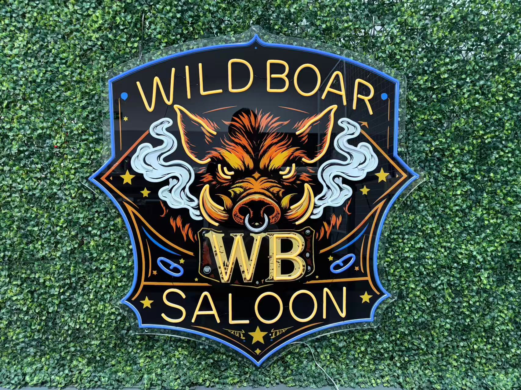 Close-up of the actual Wild Boar sign showing the raised silicone LED tubes and acrylic backing.