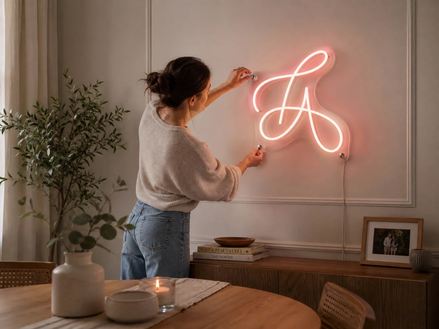 A customer installing a finished custom Pure LED neon sign at home