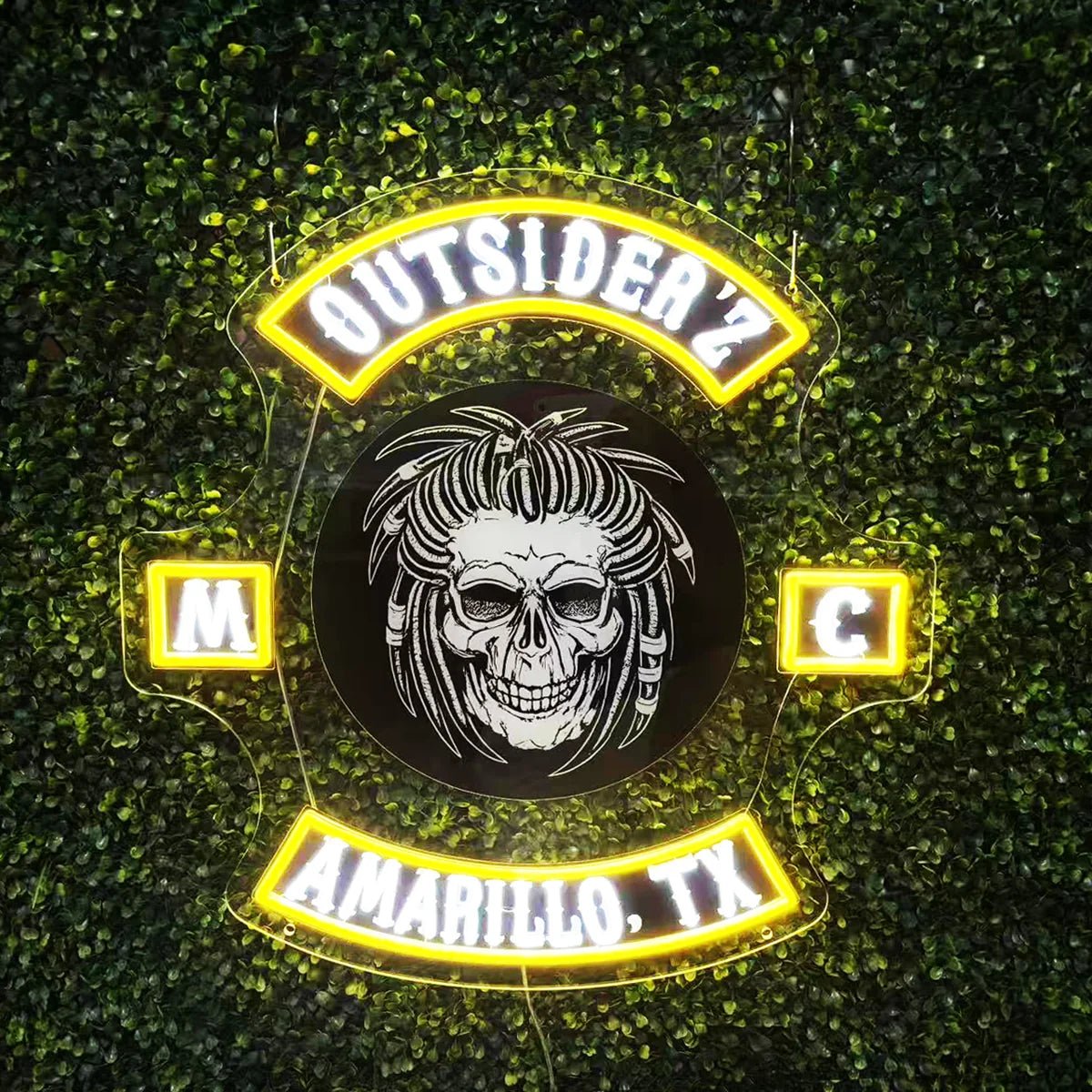 Finished Outsiderz LED neon sign illuminated on a green wall
